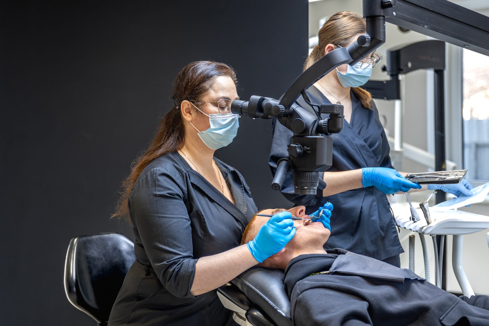 team-dentists-treats-patients-teeth-using-modern-equipment-dentistry-concept